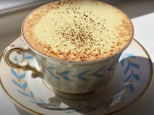 Frothy coffee with whipped yolk topping photo